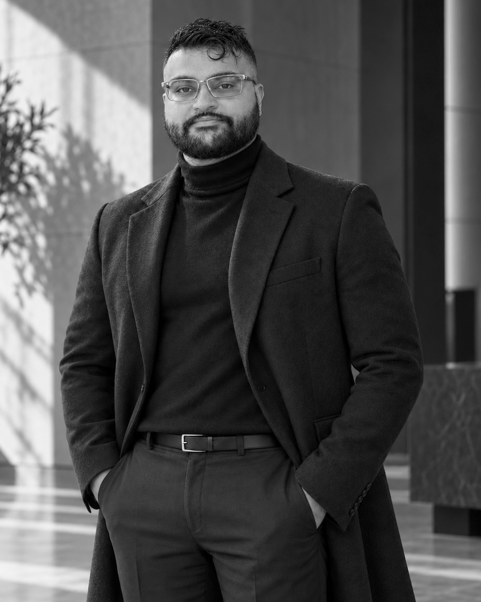 Vijay Sheth in a dark coat, standing with his hands in his pockets.